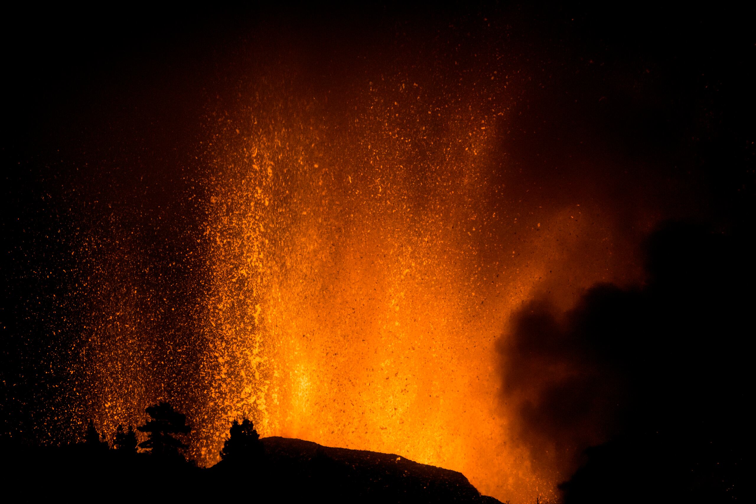 Lava flows from an eruption of a volcano at the island of La Palma in the Canaries, Spain, Sunday, Sept. 19, 2021. A volcano on Spain's Atlantic Ocean island of La Palma erupted Sunday after a weeklong buildup of seismic activity, prompting authorities to evacuate thousands as lava flows destroyed isolated houses and threatened to reach the coast. New eruptions continued into the night. (AP Photo/Jonathan Rodriguez)