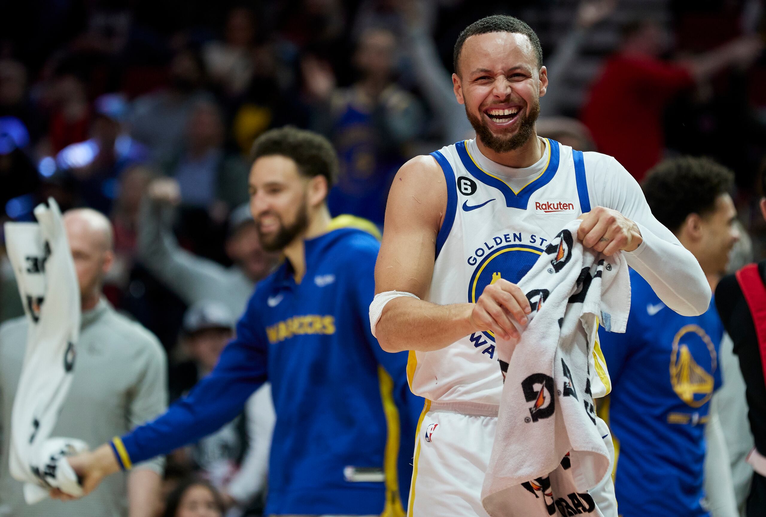 Golden State Warriors guard Stephen Curry (30) reacts after a basket by forward Jonathan Kuminga during the second half of an NBA basketball game in Portland, Ore., Sunday, April 9, 2023. (AP Photo/Craig Mitchelldyer)