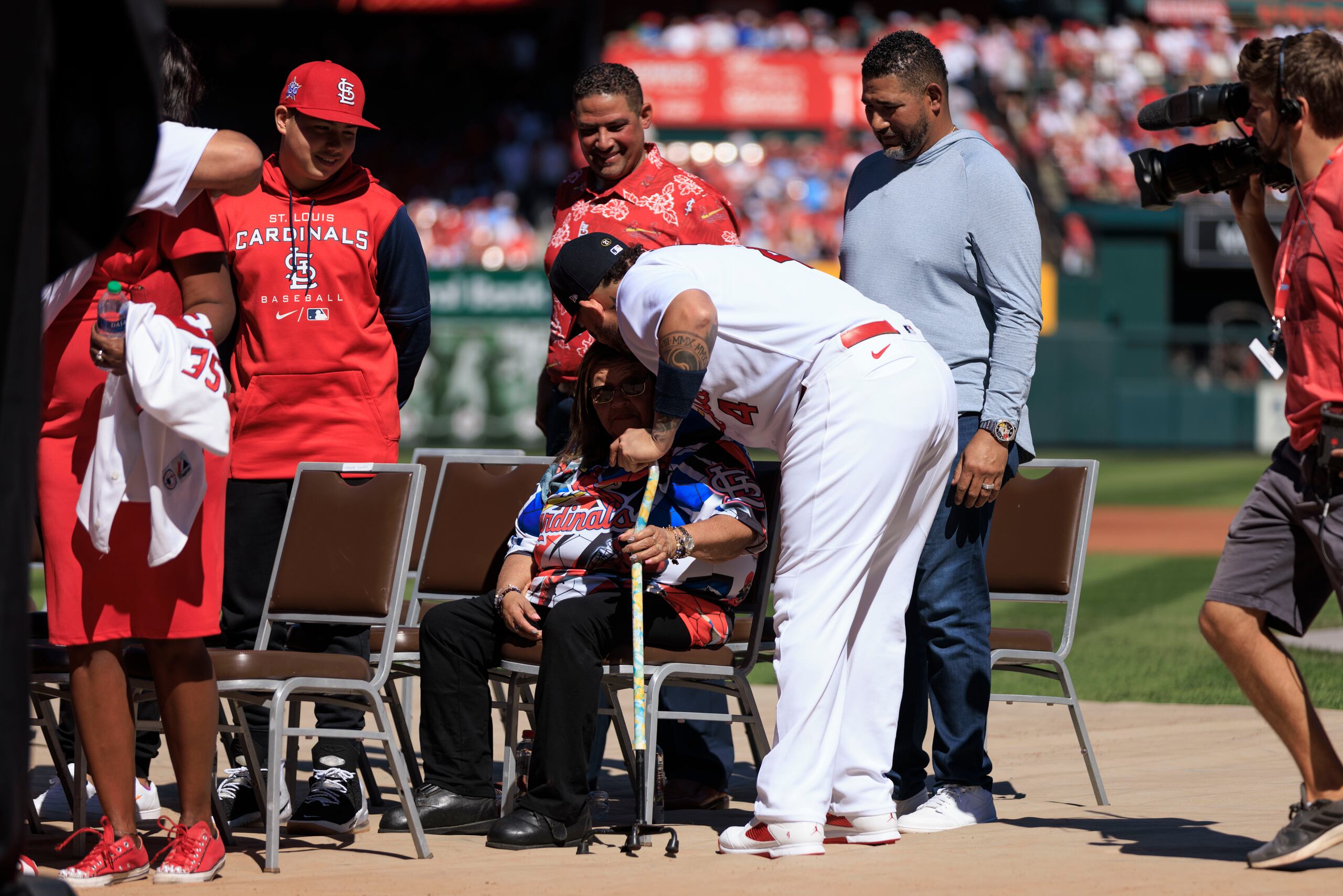 Yadier Molina abraza a su madre Gladys Matta mientras sus hermanos Bengie y José 'Cheo' Molina lo observan tras ver también la ceremonia.