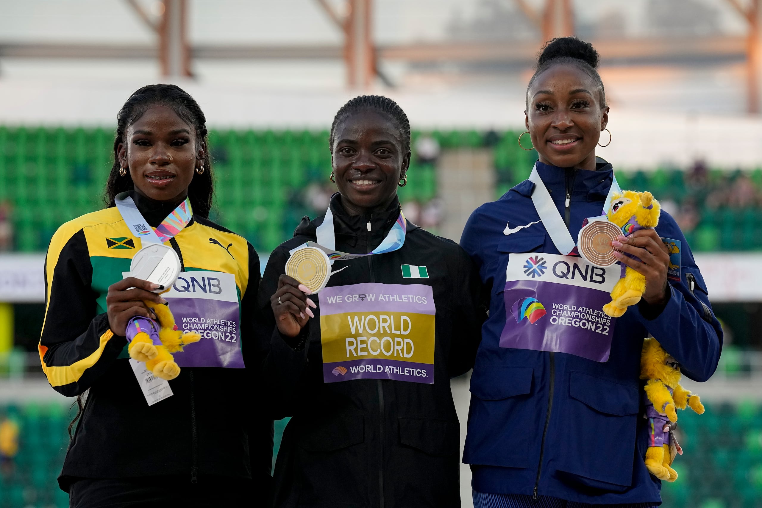 La ganadora de l a medalla de oro del pasado Mundial de Atletismo, Tobi Amusan, de Nigeria, al centro, posa junto a la medallista de plata, Britany Anderson, de Jamaica, a la izquierda, y junto a la ganadora de la medalla de bronce, Jasmine Camacho Quinn de Puerto Rico.