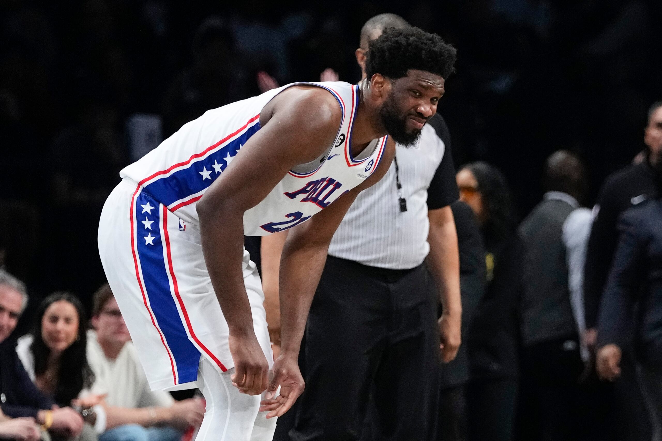 Joel Embiid, de los 76ers de Filadelfia, reacciona después de lastimarse durante la segunda mitad del partido del jueves ante los Nets de Brooklyn.