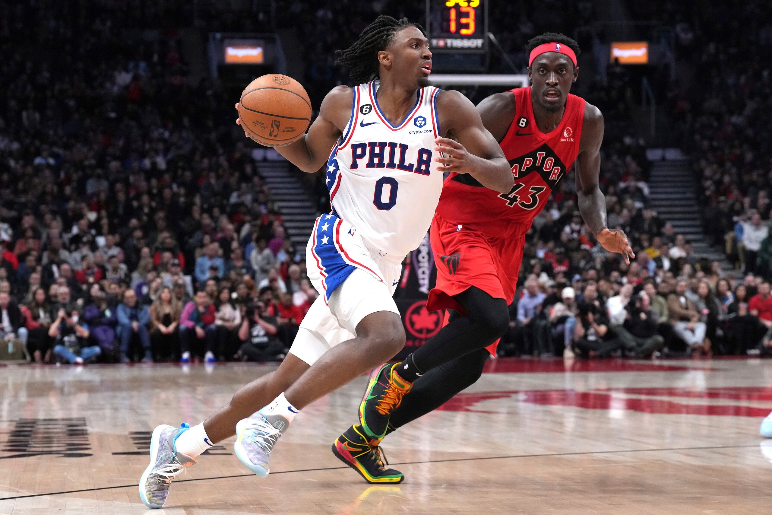 Tyrese Maxey, de los Sixers, con el balón, es seguido por Pascal Siakam, de los Raptors de Toronto.