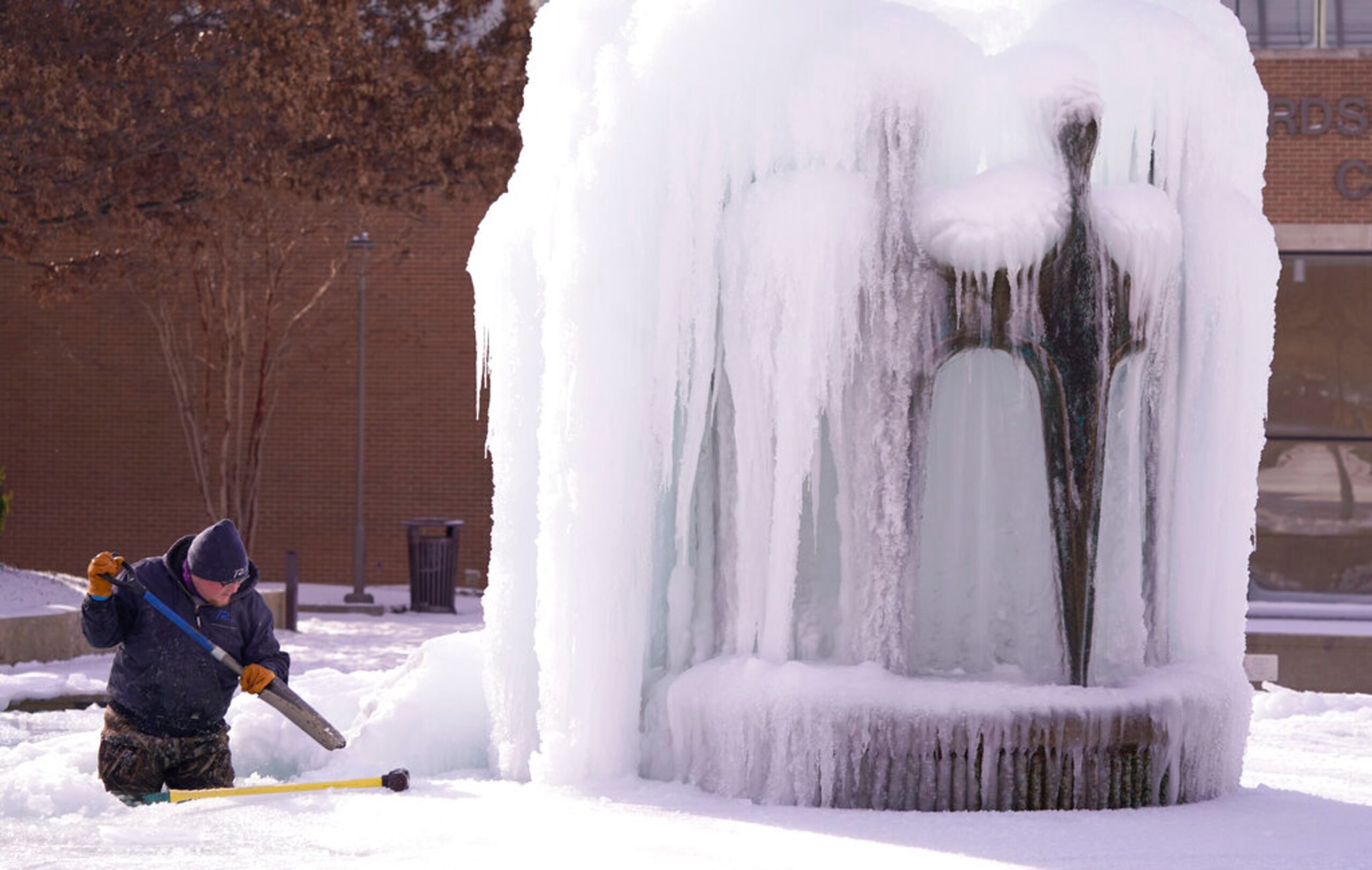 Kaleb Love limpia el hielo de una fuente de agua en Richardson, Texas.