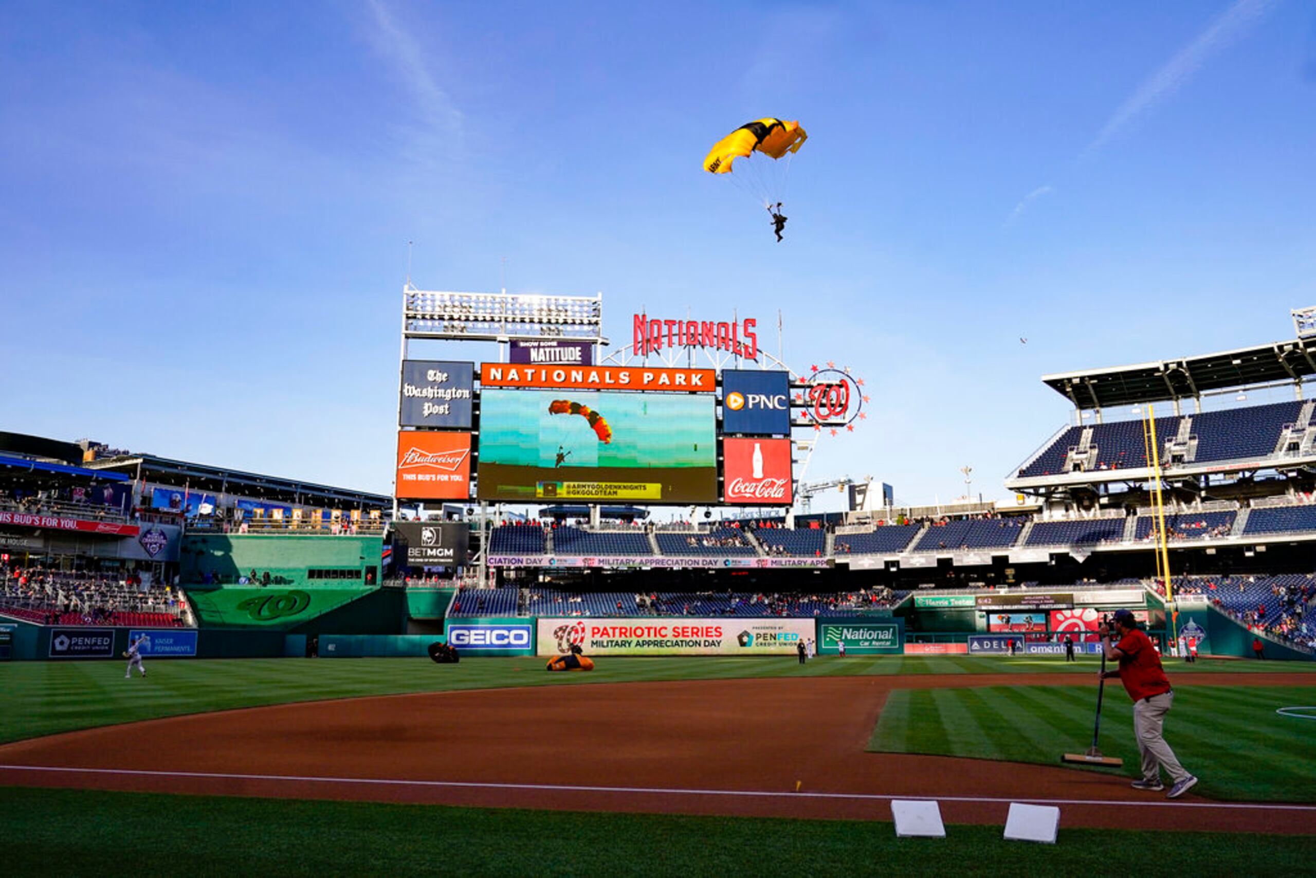 El equipo de paracaidistas del Ejército de Estados Unidos Golden Knights desciende en el Nationals Park antes de un partido de béisbol entre los Nacionales de Washington y los Diamondbacks de Arizona el 20 de abril de 2022, en Washington, D.C.