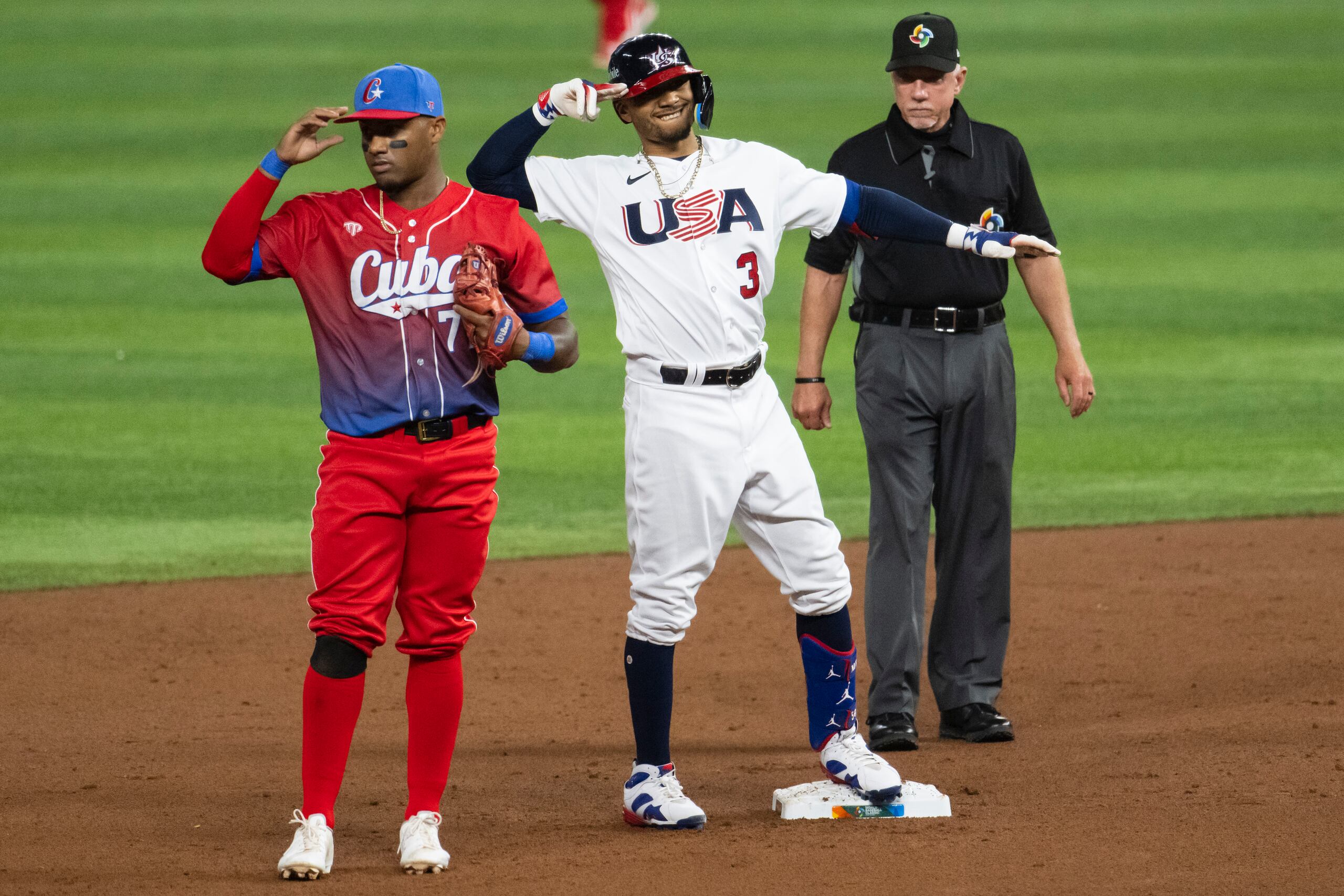 Mookie Betts, de Estados Unidos, celebra celebra llegar a segunda mientras Andy Ibáñez, de Cuba, mira hacia el otro lado.