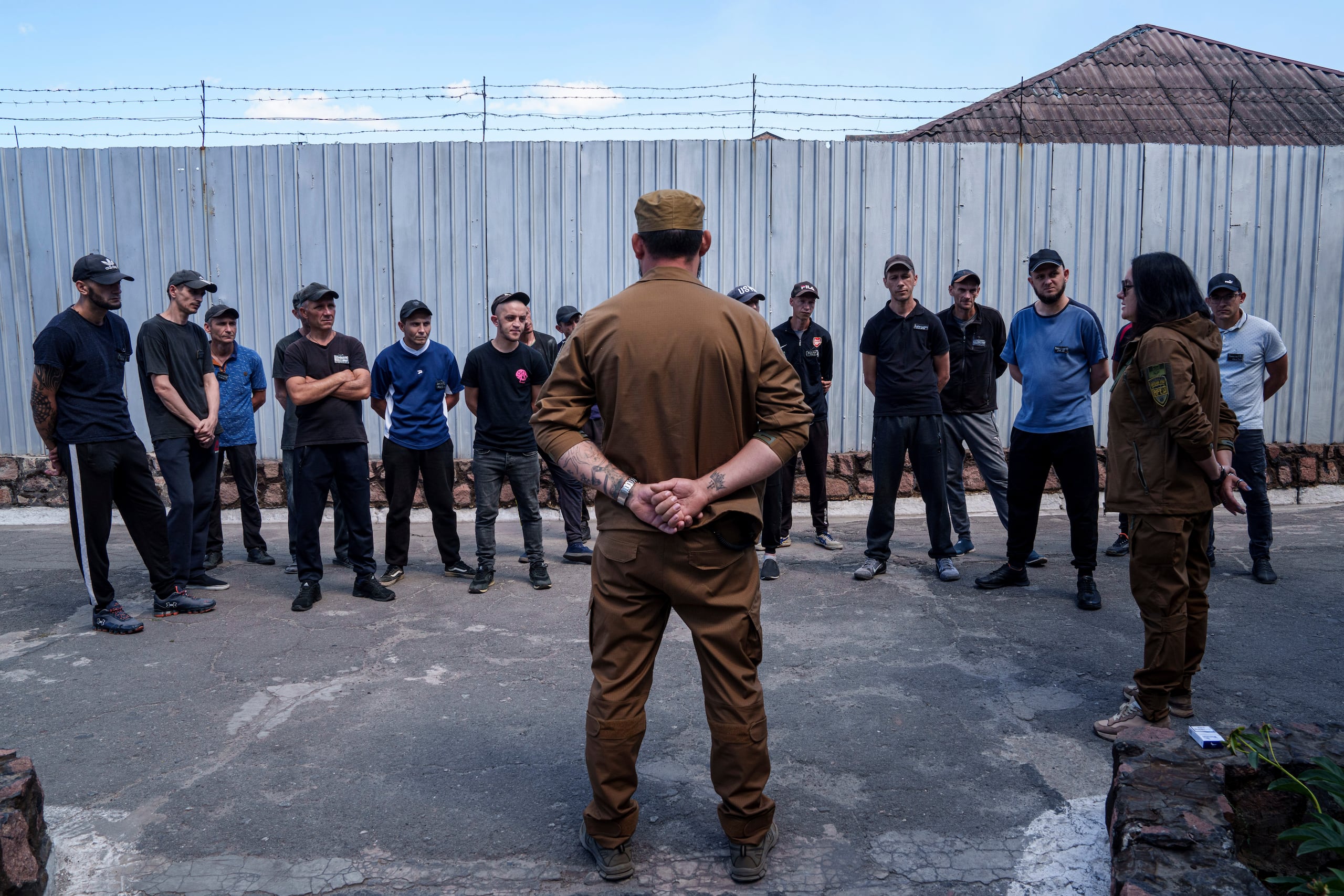 Un grupo de reos escucha a un sargento del Batallón Arey de las fuerzas ucranianas durante una entrevista en prisión, en la región de Dnipropetrovsk, Ucrania, el viernes 21 de junio de 2024. (AP Foto/Evgeniy Maloletka)